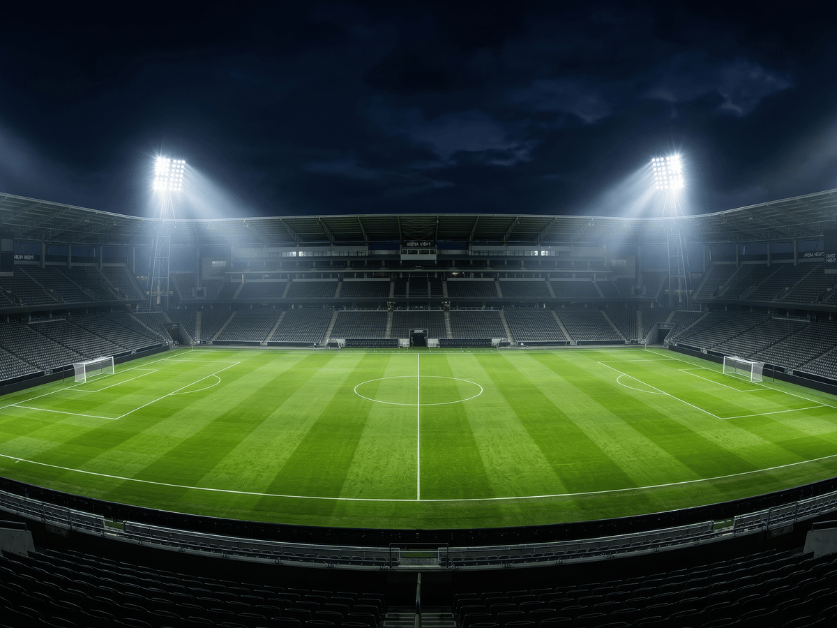 An empty stadium at night under floodlights