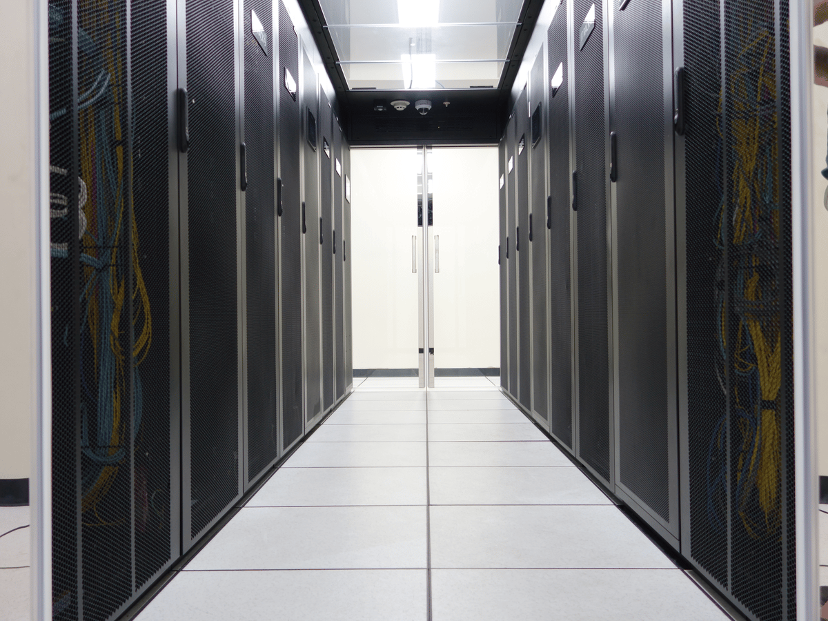A row of server racks in a bright data centre