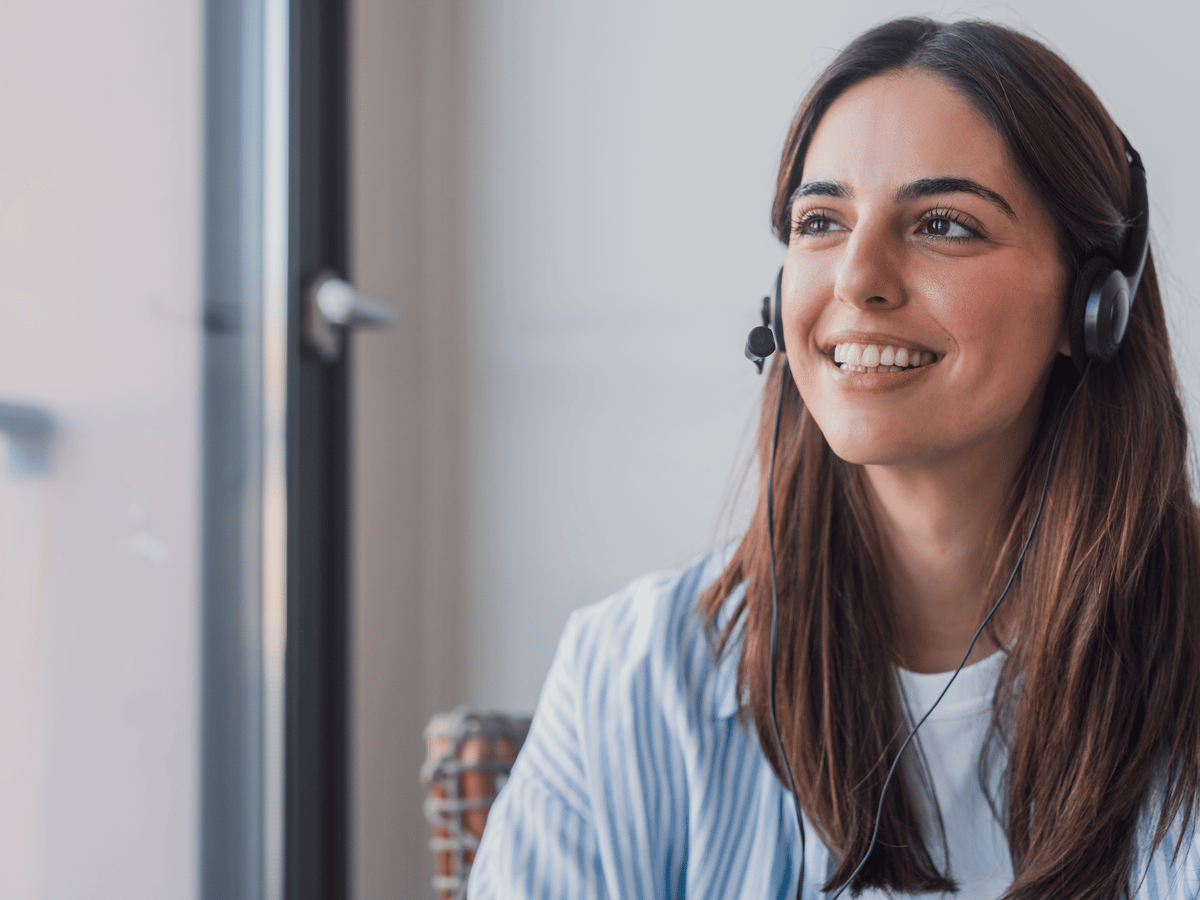A support agent on a headset helping a customer