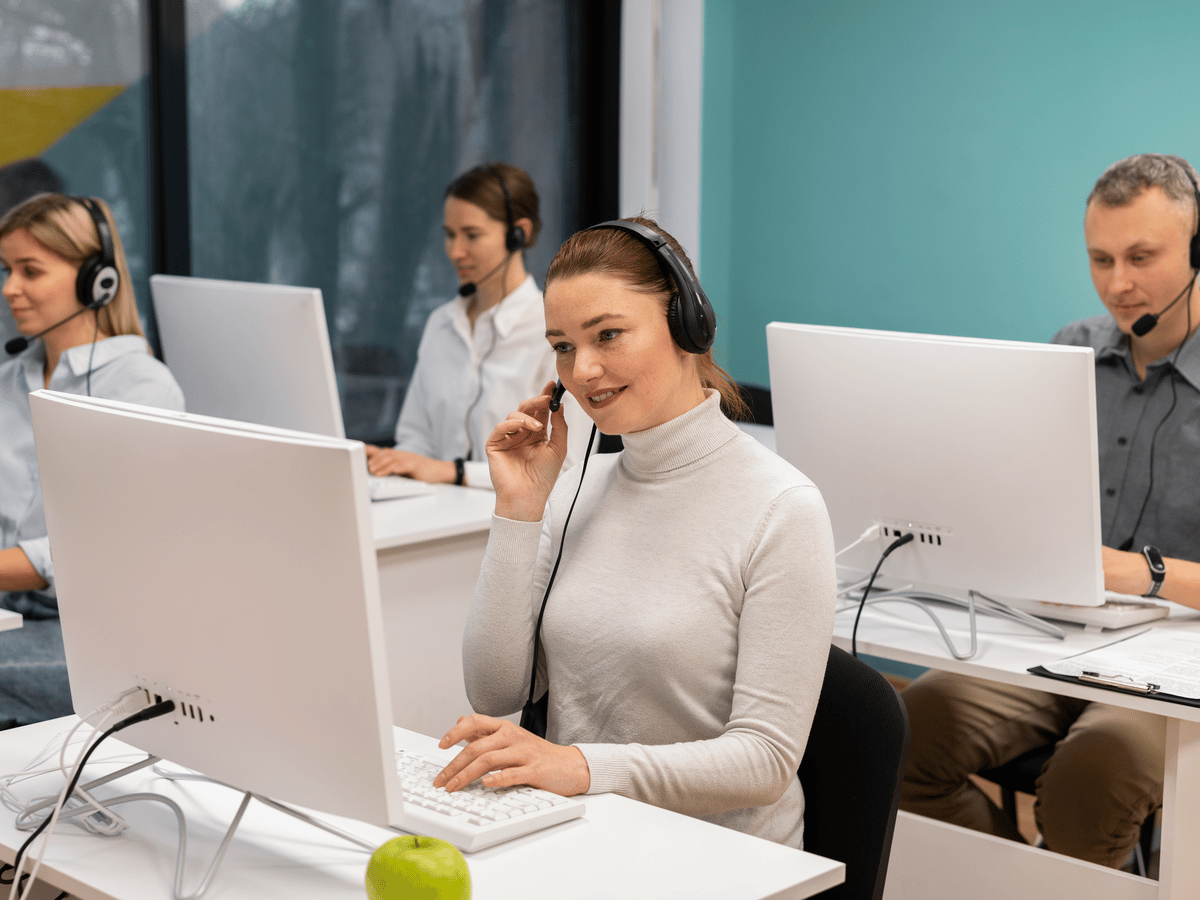 A service desk team on headsets at their workstations